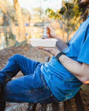 Man Easting out of Natural tray