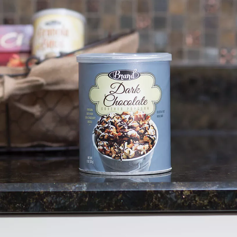 Paper container of dark chocolate granola sitting on a counter