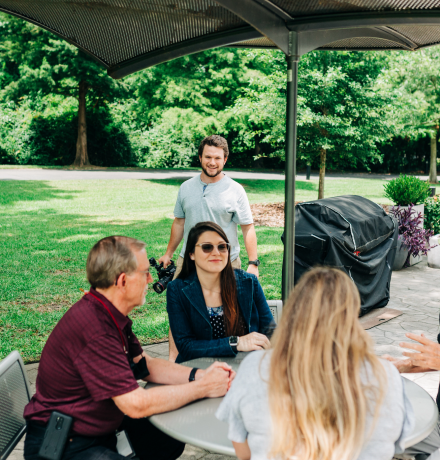 People sitting at a table in an outdoor park