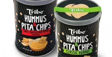 Two paper containers of Tribe brand hummus and pita chips with clear lids