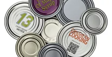 Multi varied can end types laying together with different prints and codes on them