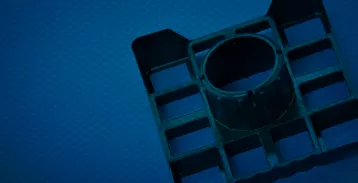 Black plastic fixture on a blue background