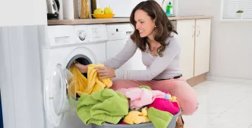 Woman unloading a dryer