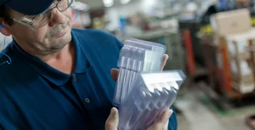 Man holding plastic containers