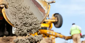 Wet cement coming out of a machine