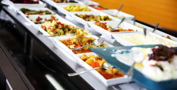 Food arranged in serving trays on a buffet