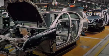 The shell of a car on a factory floor