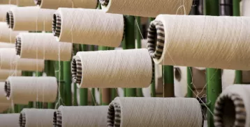 Cardboard tubes with thread wrapped around them