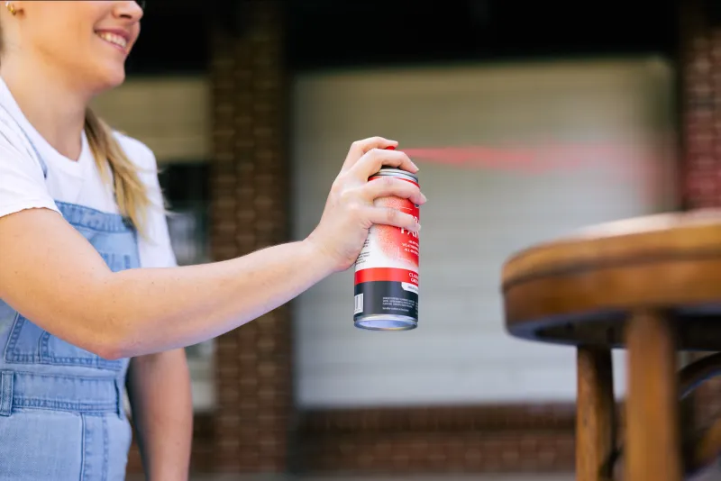 Woman using an aerosol spray paint can