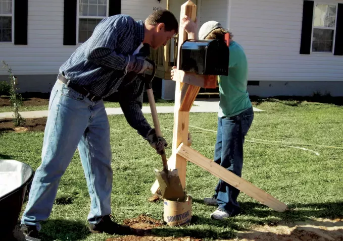 Father and son use Builder's Tube to install a mailbox.